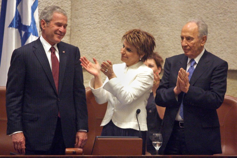 President George W. Bush smiles as Israeli Parliament Speaker Dalia Itzik and President Shimon Peres applaud following his address to Israel's parliament on May 15, 2008.