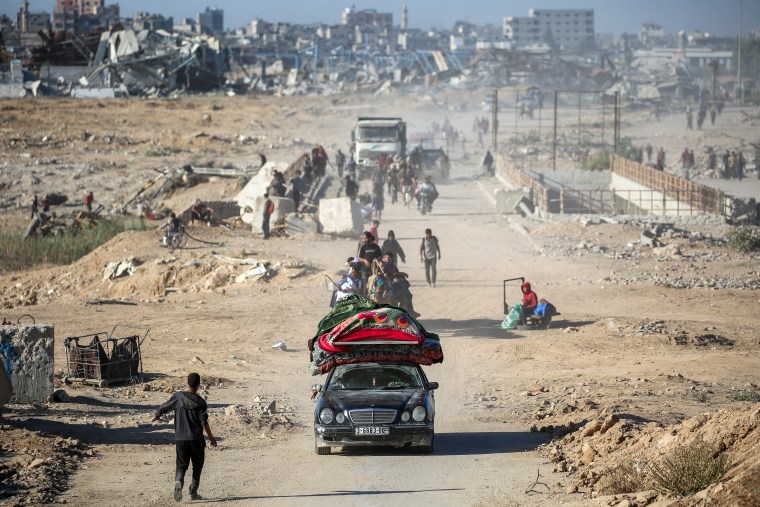 Palestinians make their way to Gaza City from Nuseirat in the central Gaza Strip today.