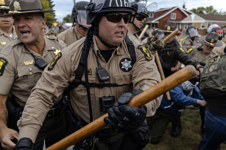 An Illinois State police officer confronts protesters outside the Broadview ICE processing facility in Broadview, Ill., on Friday, Oct. 10, 2025.