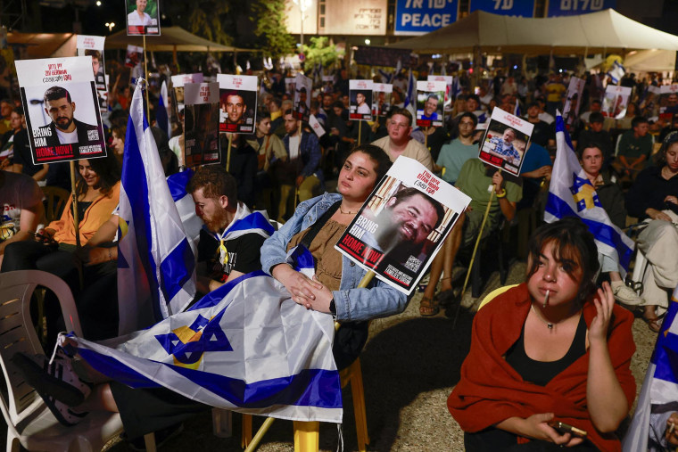 People gather at Hostages Square in Tel Aviv early on Oct. 13, 2025.