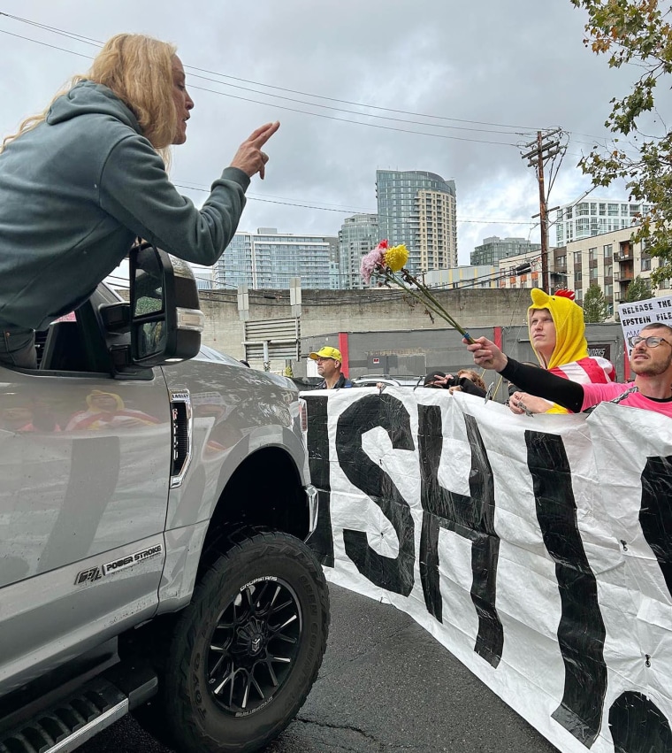 A woman in a truck confronts anti-ICE protesters outside the immigration processing center in south Portland