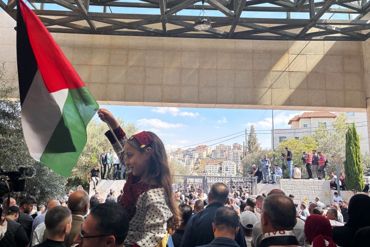 Families wait outside the Ramallah Cultural Palace for the Palestinian prisoners to be released on Monday.