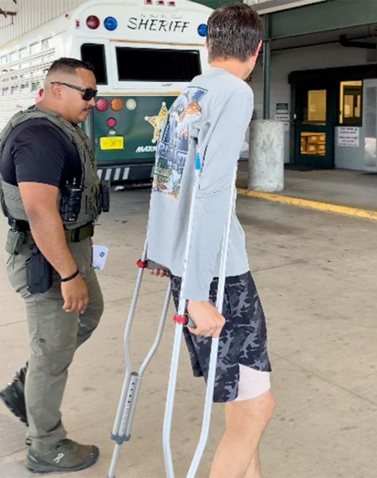 Caden Speight, 17, is escorted by an officer with the Marion County Sheriff's Office.