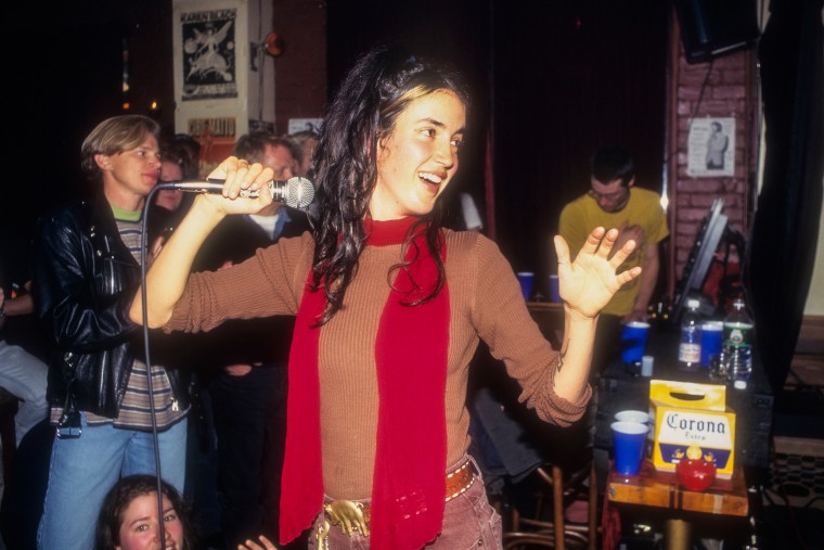 Kinnie Starr holds the microphone as she performs with her band at Meow Mix.