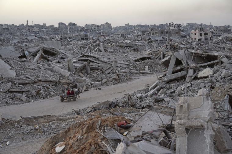 Palestinians travel by horse cart amid the destruction in the Sheikh Radwan neighborhood in Gaza City on Oct. 22, 2025. 