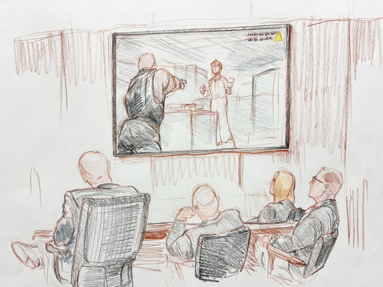 The defense team watches body camera video depicting the shooting in court. From left: defense attorney Daniel Fultz, defense attorney Mark Wykoff, attorney Natalia Galica and defendant Sean Grayson.