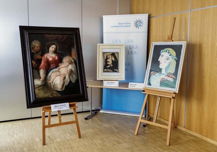 Three out of some 20 counterfeit paintings confiscated by the police are on display in the premises of the Bavarian State Criminal Investigation Department in Munich.
