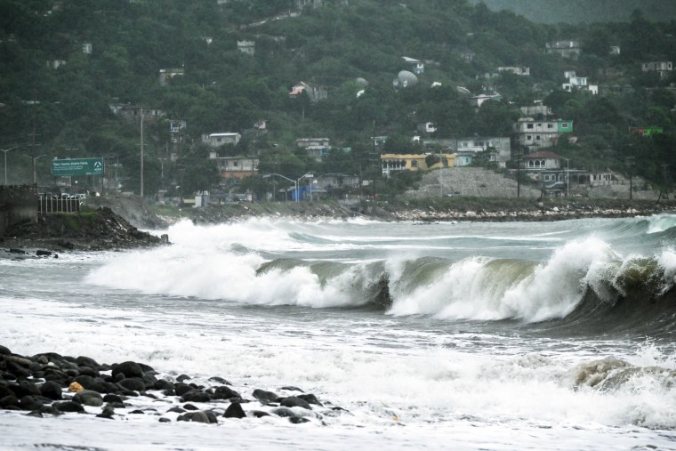 An ocean wave crashes by the shore