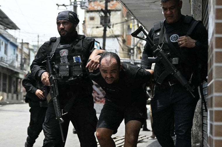 Image: TOPSHOT-BRAZIL-CRIME-DRUGS-FAVELA-POLICE-RAID