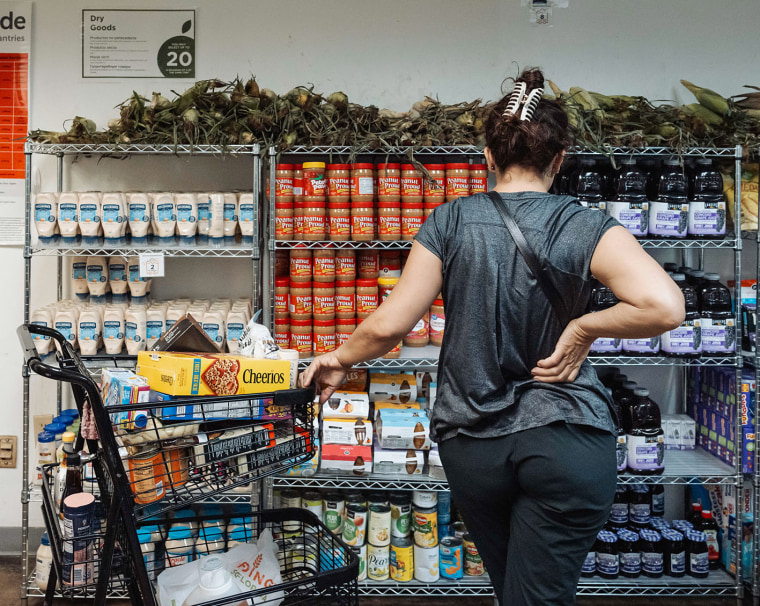 A resident browses donated food items in the pantry at Feeding South Florida in Pembroke Park on Friday, Oct. 31, 2025.