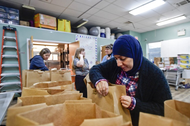 Volunteers at the Lutheran Settlement House pack bags of groceries to distribute to the local community in Philadelphia on Oct. 30, 2025.