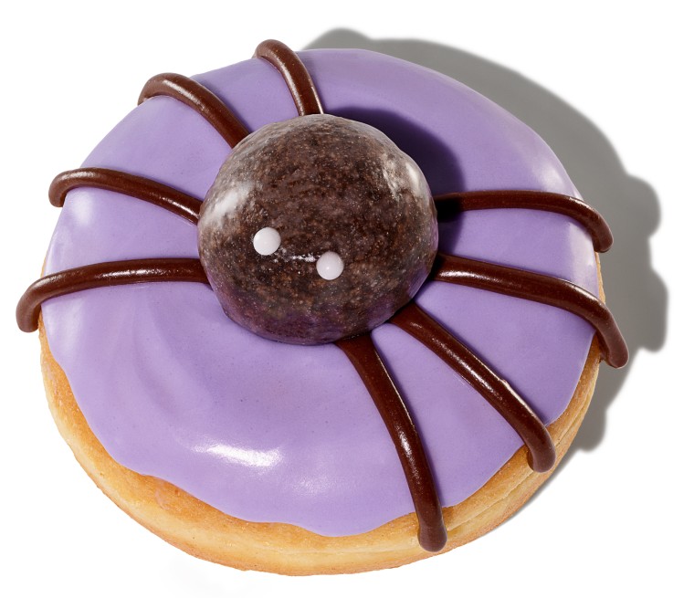 A purple doughnut with a spider decoration on top.
