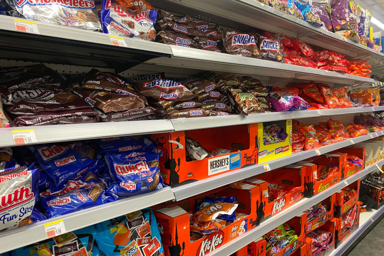 Assorted bags of Halloween candy on display.