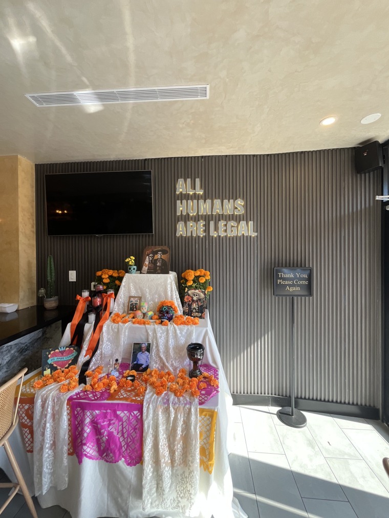 Inside Whitexicans, a sign reads "All humans are legal."