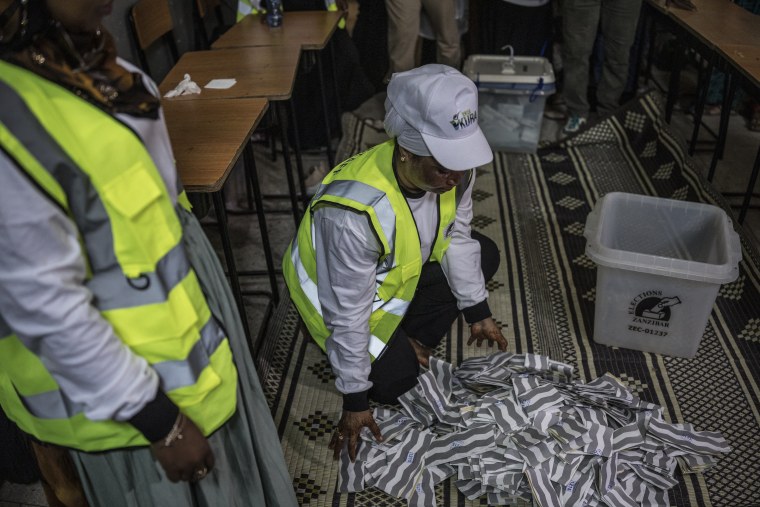 Polling station officials spread the ballots at the beginning of the counting operations in Stone Town on Oct. 29.