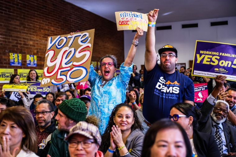 People cheer during a campaign event in support of Prop 50 in San Francisco.
