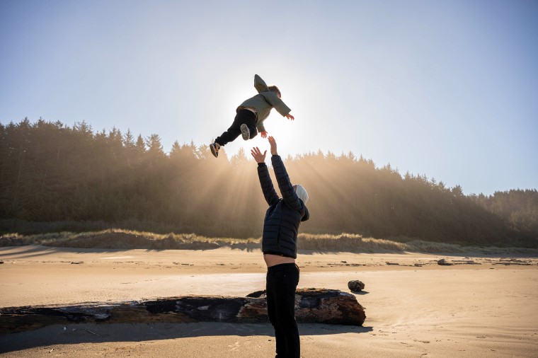 Colin O'Brady tosses his two-and-a-half-year-old son Banks in the air.