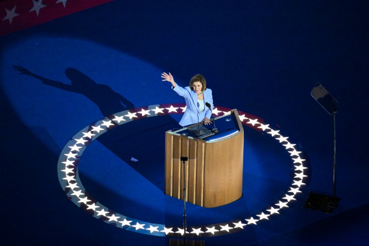 Former US House Speaker Nancy Pelosi waves as she arrives onstage to speak on the third day of the Democratic National Convention.