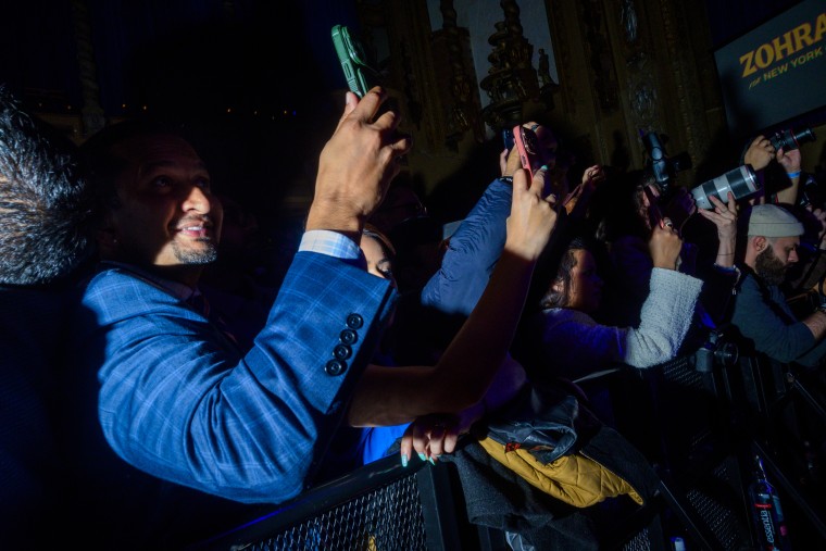 Supporters watch New York City Democratic mayoral campaigner Zohran Mamdani speak
