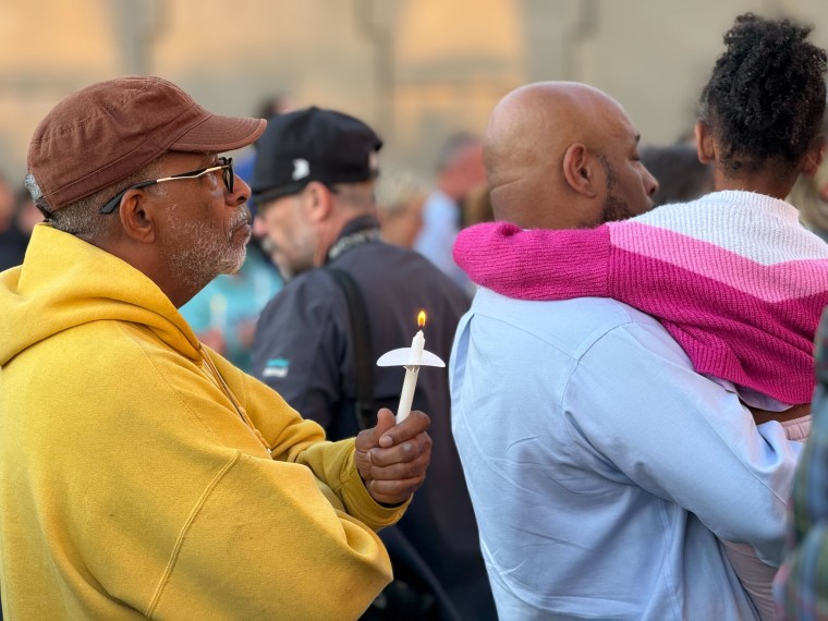 People gather outside the Teamsters Local 89 on Thursday for a vigil for the victims of a UPS plane crash this week in Louisville, Kentucky.