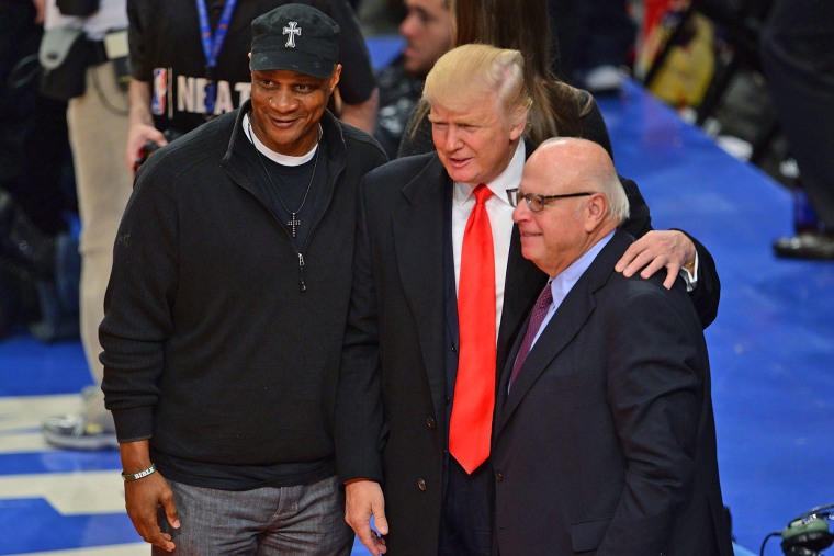 Darryl Strawberry, Donald Trump and an undientified guest attend a New York Knicks game in 2012.