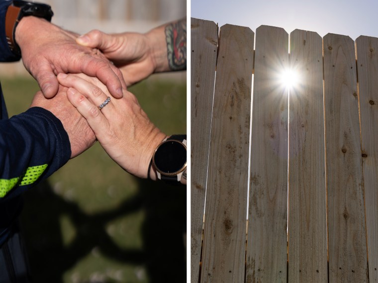 Jane Doe holds hands with her husband; the sun shines through a gap the yard fence.