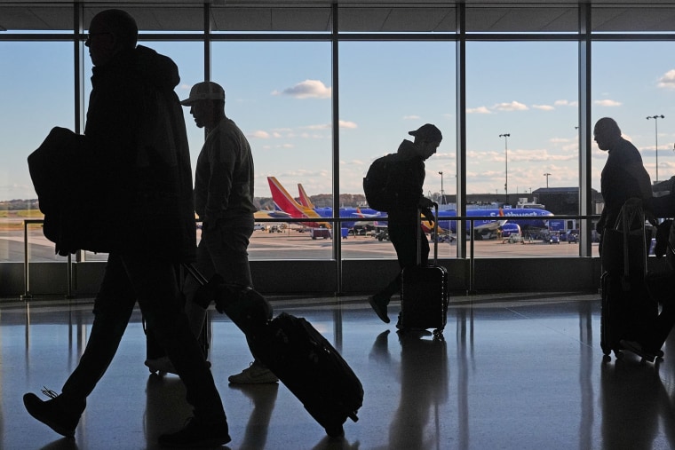 Travelers walk through Baltimore/Washington International Thurgood Marshall Airport on Monday, Nov. 10, 2025. 