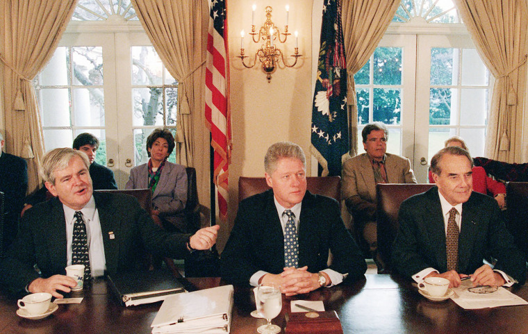 House Speaker Newt Gingrich, left, gestures during a budget meeting with President Bill Clinton and Senate Majority Leader Bob Dole on Dec. 31, 1995.