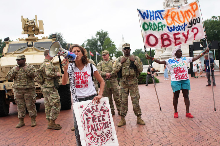 Protesters demonstrate near members of the National Guard  in Washington, D.C.