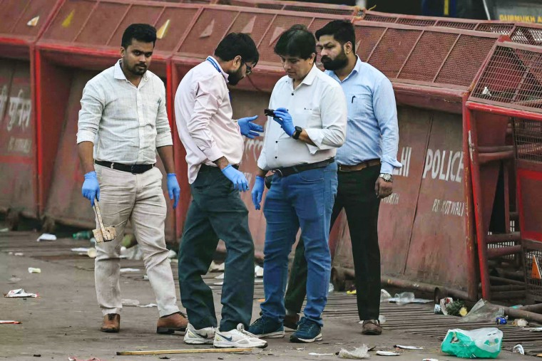 Forensic experts inspect the blast site after an explosion near the Red Fort in the old quarters of Delhi
