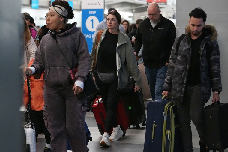 Travelers walk though the terminal at O'Hare International Airport in Chicago, Wednesday, Nov. 12, 2025. 