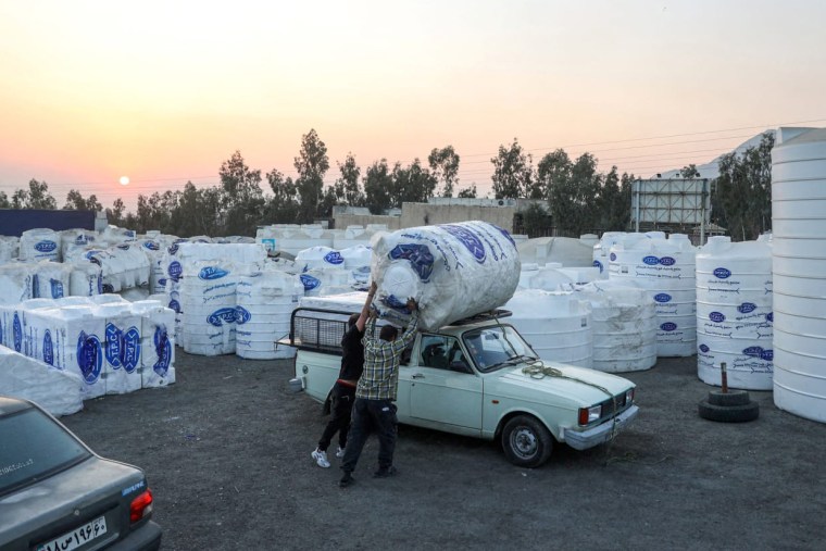 People shop for water storage tanks following a drought crisis in Tehran on Monday.