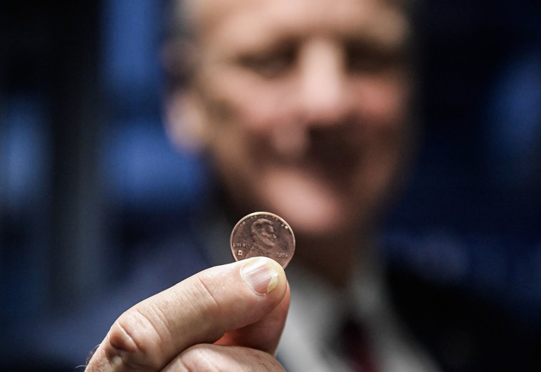 U.S. Treasurer Brandon Beach holds the last penny stamped at the U.S. Mint on Nov. 12, 2025 in Philadelphia.