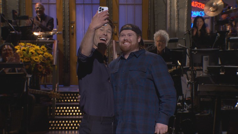 Image: Glen Powell and Mitch the UPS guy.