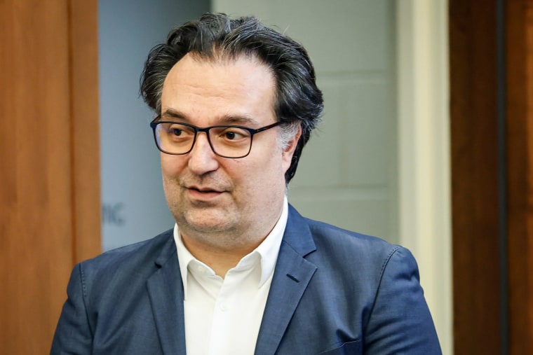 Brian Walshe walks into a courtroom