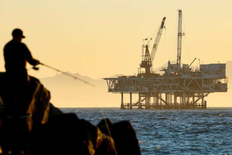 A person fishes with offshore oil and gas platform in California. 