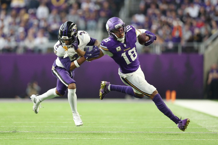 Justin Jefferson #18 of the Minnesota Vikings carries the ball defended by Nate Wiggins of the Baltimore Ravens on Nov. 9, 2025 in Minneapolis, Minnesota.