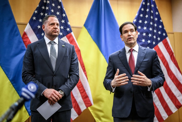 Andriy Yermak, left, and Marco Rubio stand next to each other in front of American and Ukranian flags, as Marco speaks