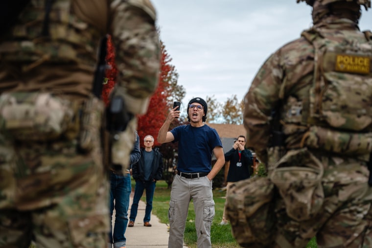 A young man confronts federal agents after they arrested a worker at home in Chicago's Edison Park neighborhood on Oct. 31, 2025, in Chicago, Illinois. Agents gave him two warnings and threatened to arrest him for interfering with their operation.