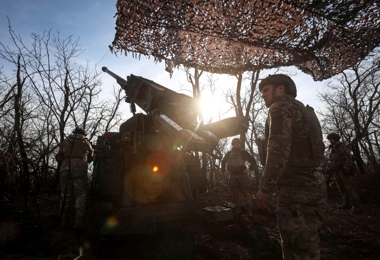 Ukrainian servicemen prepare to fire a self-propelled howitzer towards Russian troopsn near the front line town of Pokrovsk