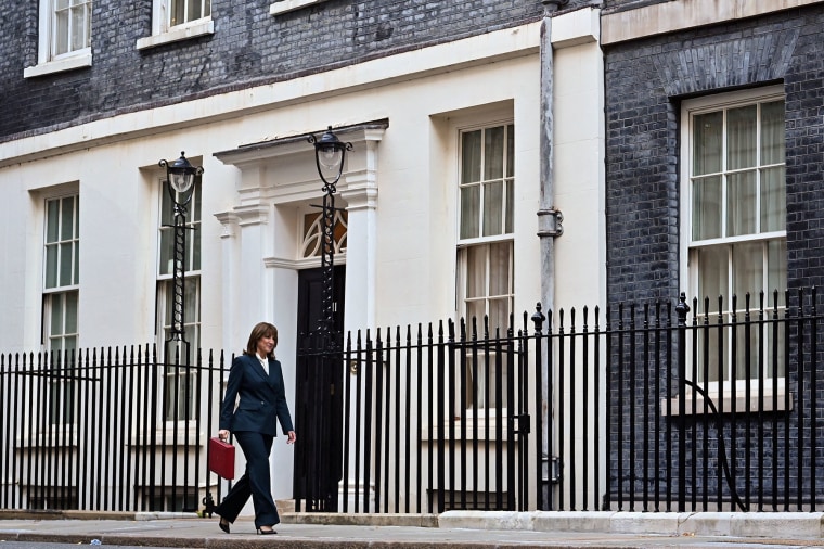 Britain's Chancellor of the Exchequer Rachel Reeves walks with the red Budget Box