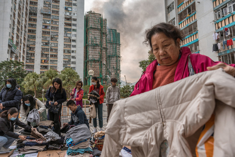 Hong Kong firefighters were scouring a still-burning apartment complex for hundreds of missing people on November 27, a day after the blaze tore through the high-rises, killing at least 44. 