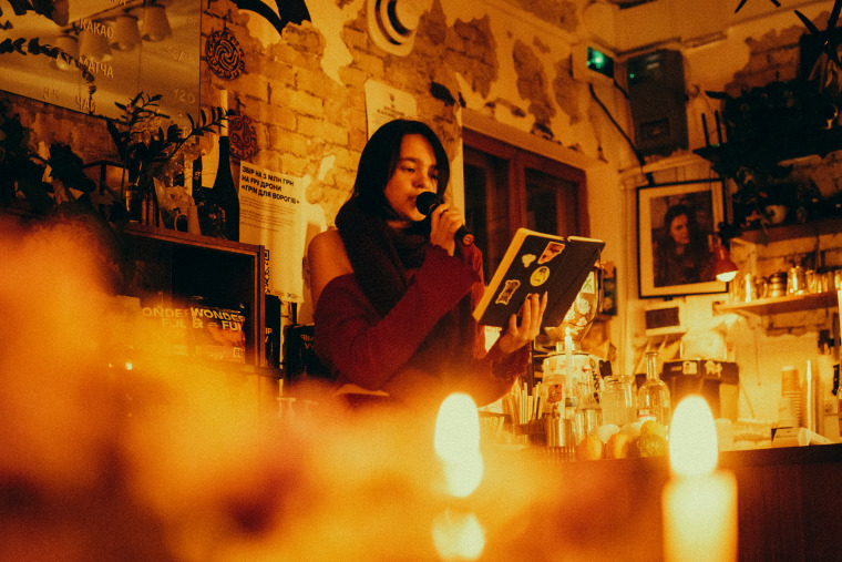 A candlelit poetry evening at Khoryv Coffee in Kyiv.