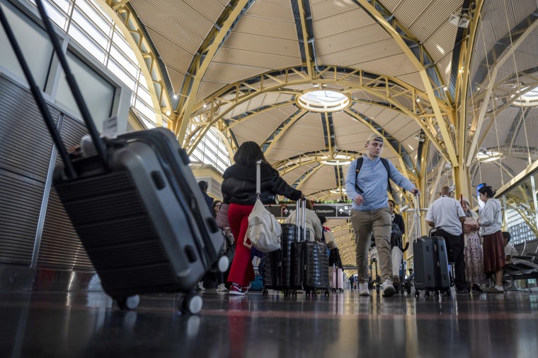 Passengers with suitcases.