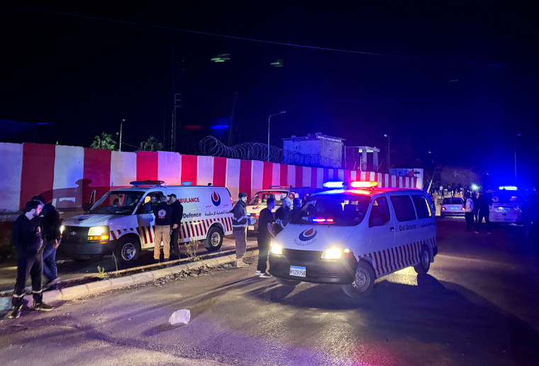 Civil defence vehicles park at the entrance of Ain al-Hilweh Palestinian refugee camp, following an Israeli strike
