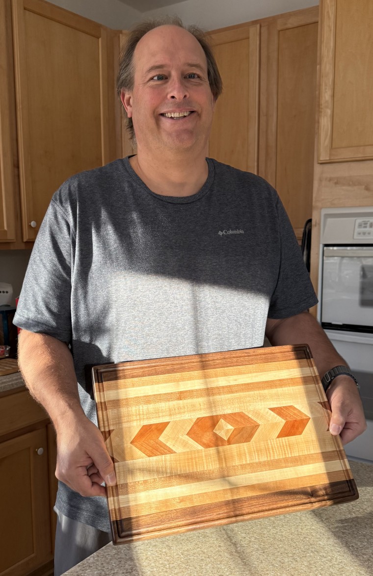 Christiansen stands with the cutting board he made for his parents this year.