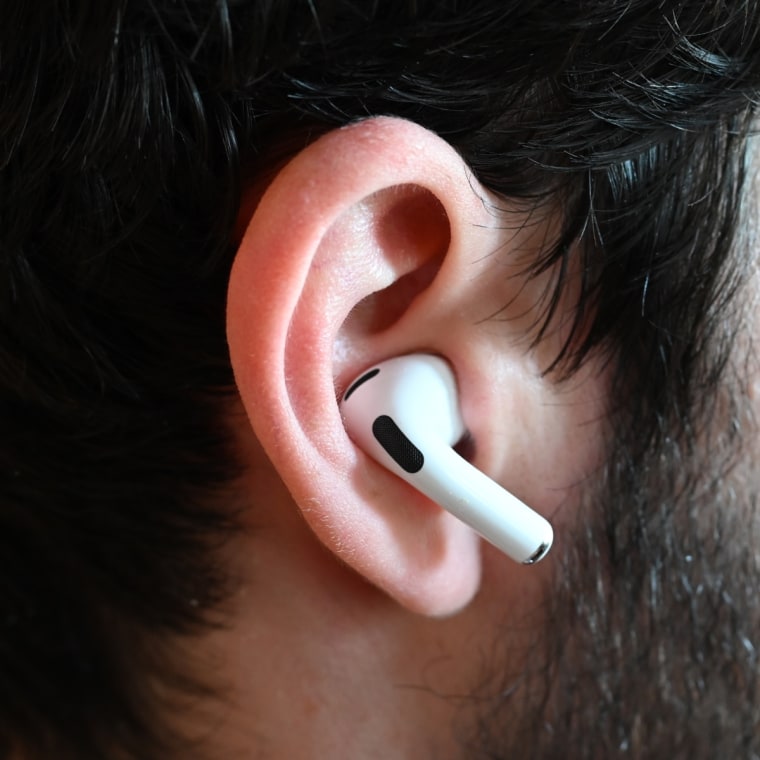 A close up of an Apple AirPods Pro 2 earbud in the ear of the writer.