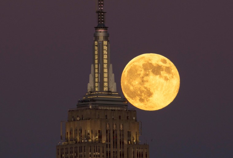 The full Beaver Supermoon rises behind the Empire State Building as the sun sets on November 15, 2024.