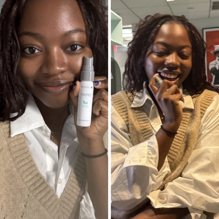 Selfie of a woman smiling while holding up the mouth spray. Image of a woman at her desk smiling while using the mouth spray.