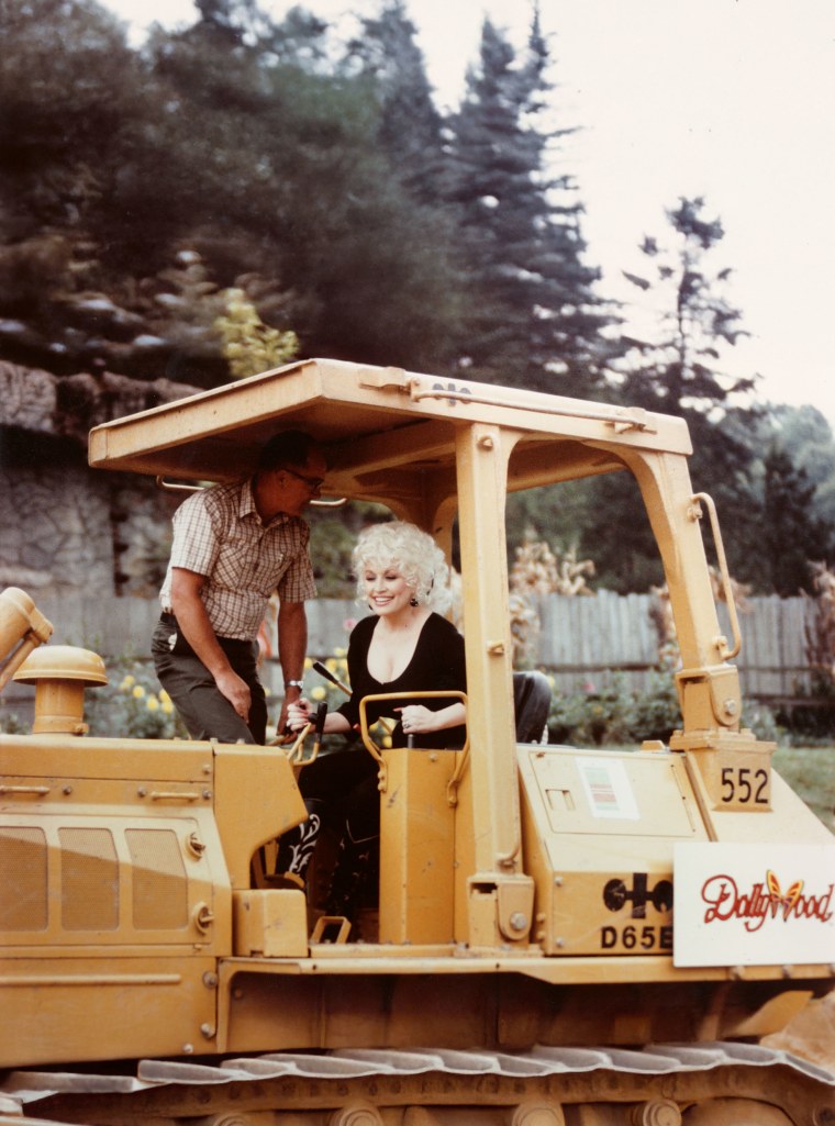 Dolly Parton on a bulldozer at the site of Dollywood.
